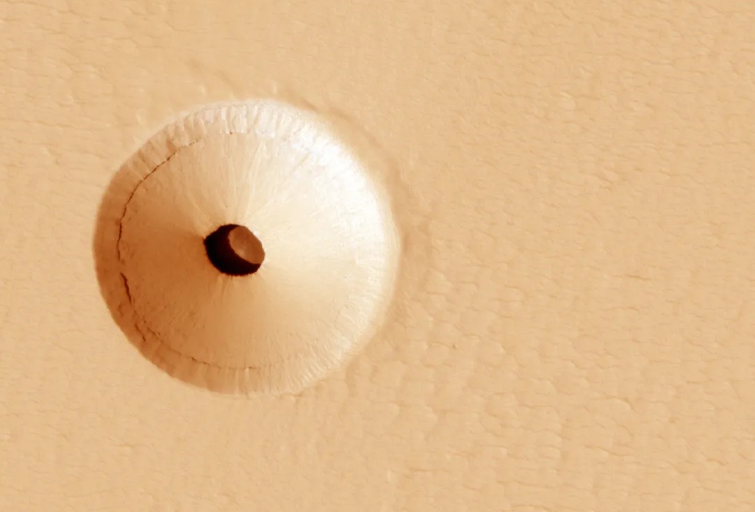 Sunken pit on Mars with 30 meter wide hole showing cavern beneath