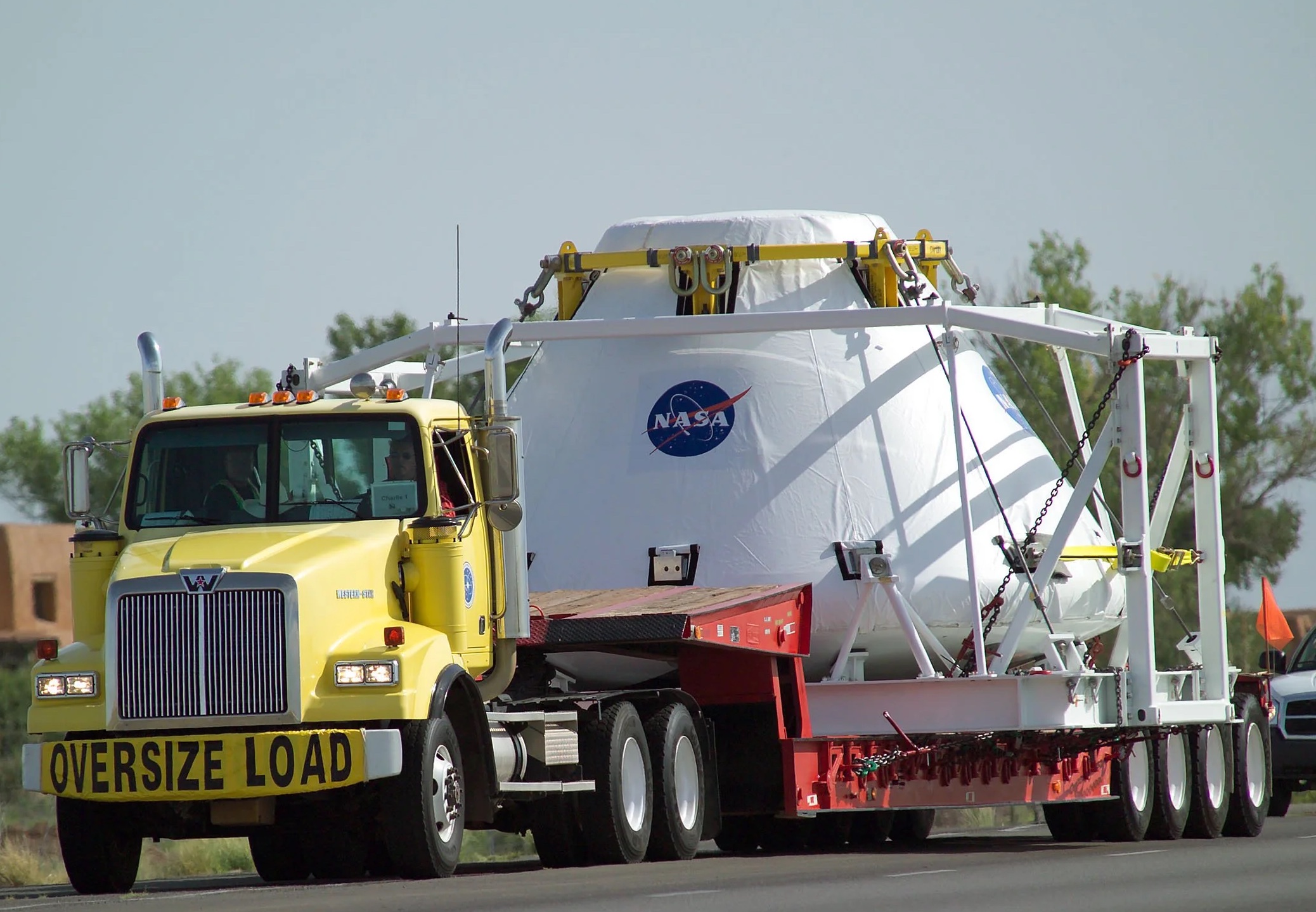 Orion space capsule with OVERSIZE LOAD banner